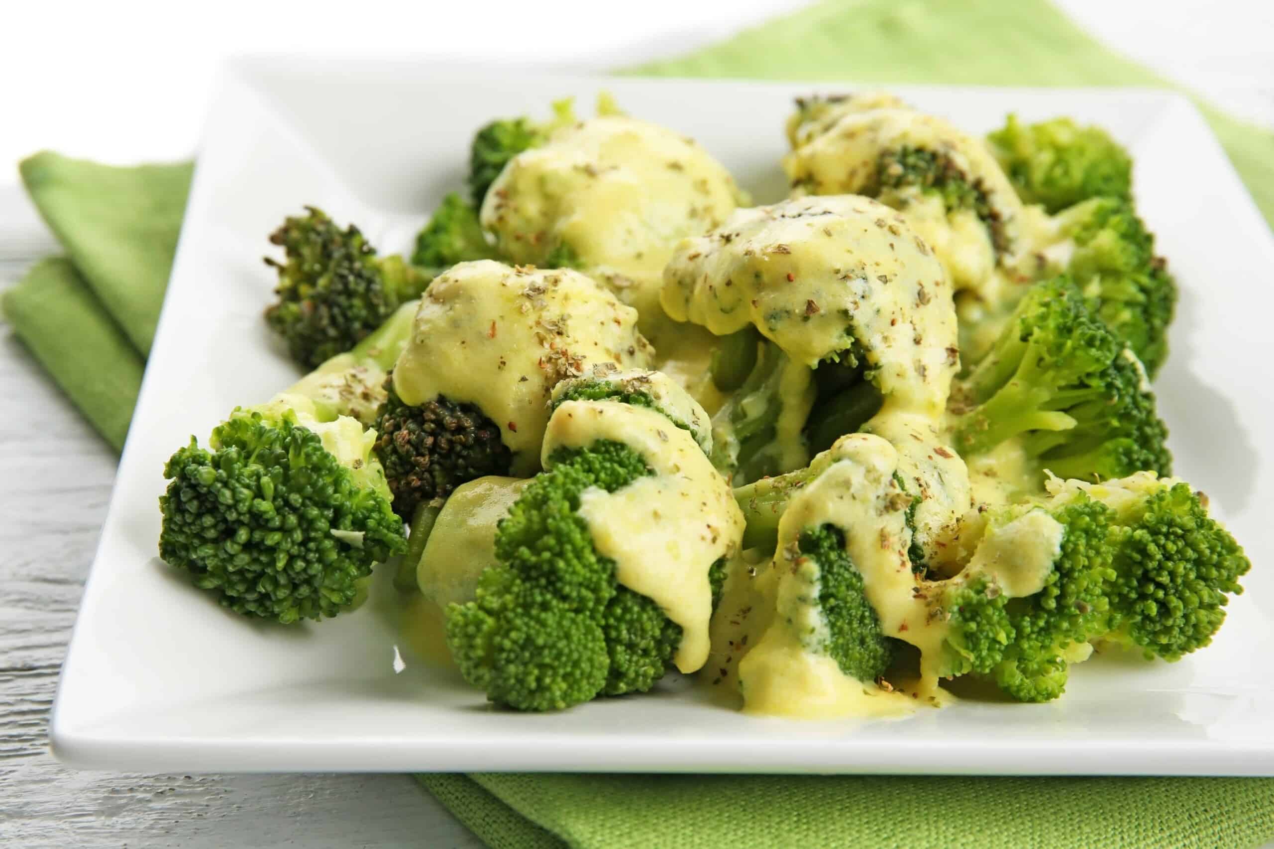 Easy after school snack for kids - Broccoli with cheese on white plate.