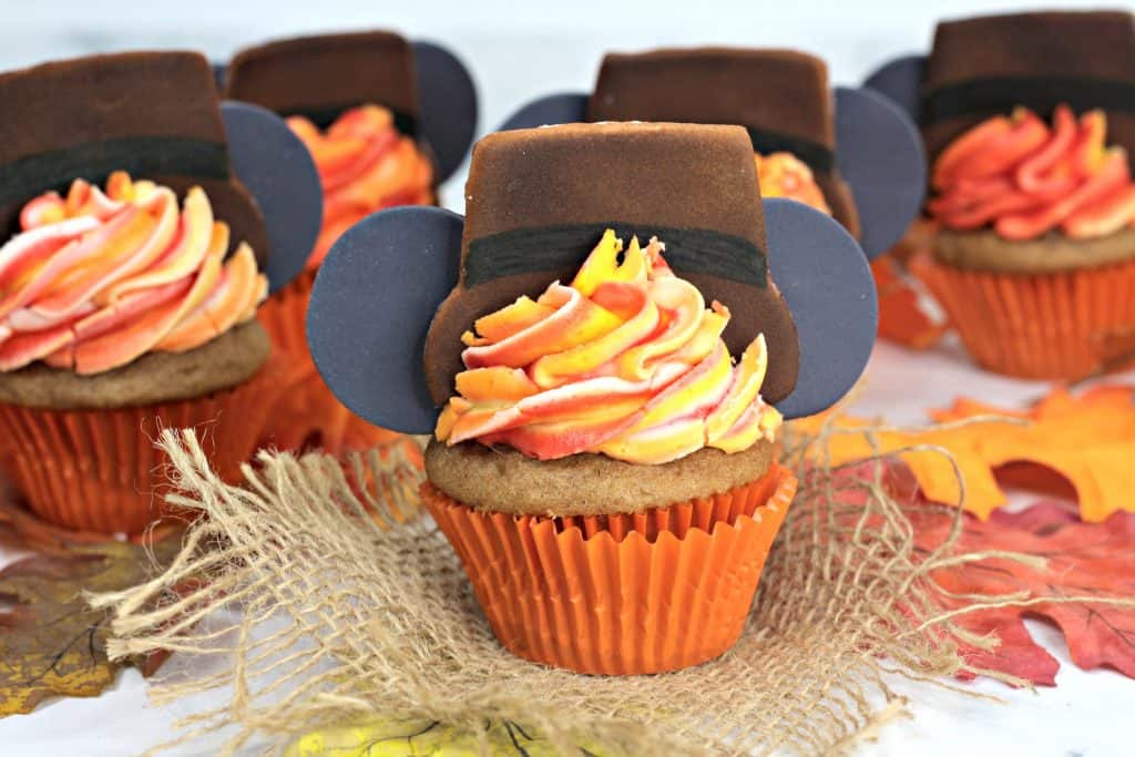 Thanksgiving cupcakes displayed on table with leaves