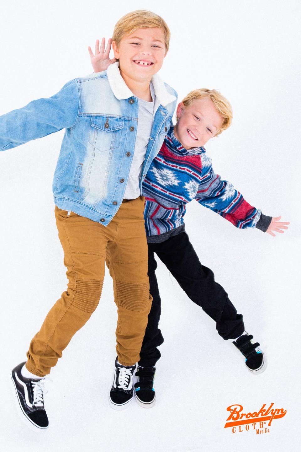 Two boys in stylish clothes hugging each other