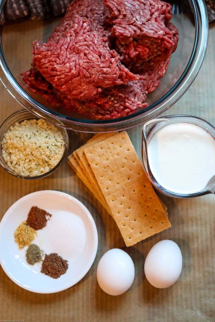 Swedish meatball ingredients set out on table. Ground beef, graham crackers, milk, spices, eggs