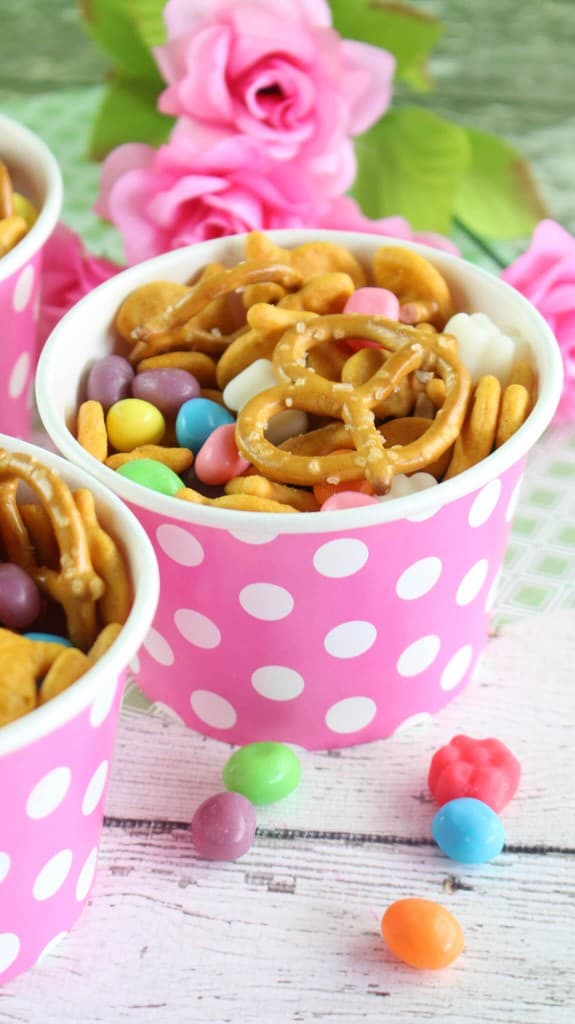 Spring snack mix in pink and white polka dot cups on table.