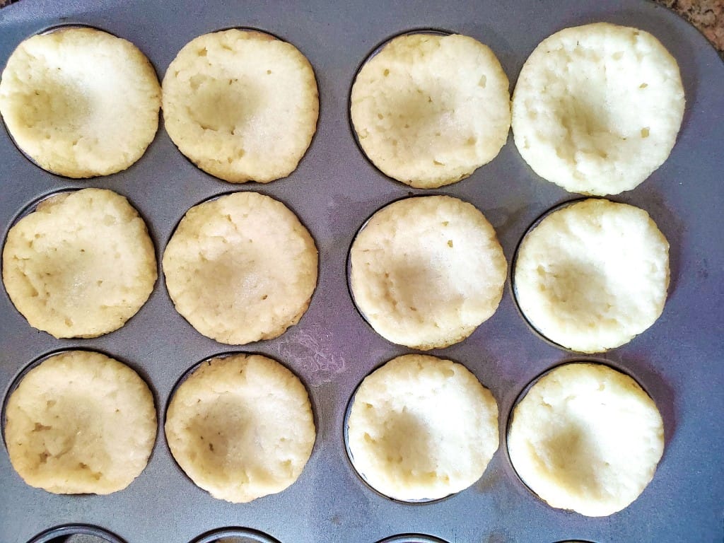 Sugar Cookie Fruit Cups - Crurst being placed in muffin cups