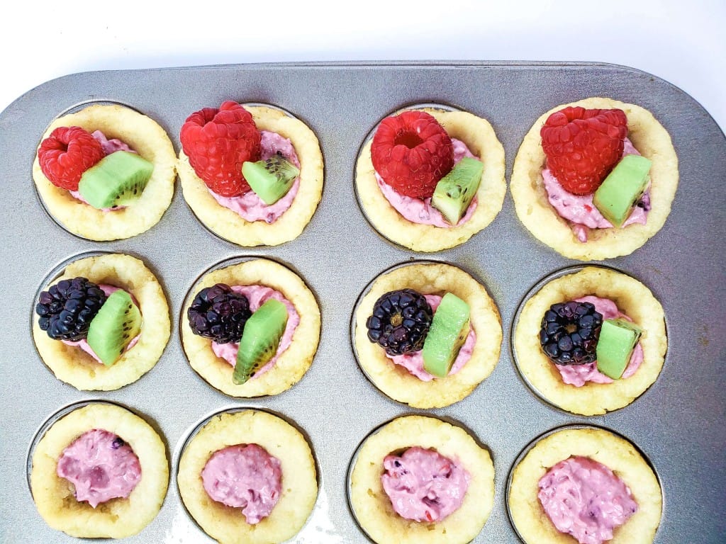 Sugar Cookie Fruit Cups - Crust placed in muffin cups with filling and fruit.