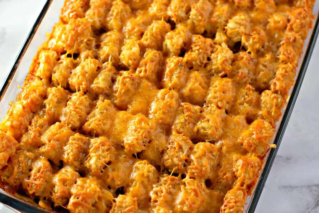 Mexican Tater tot Casserole in glass dish on marble counter
